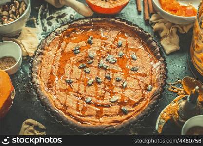 Pumpkin pie with ingredients, top view