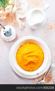 pumpkin porridge in bowl and on a table