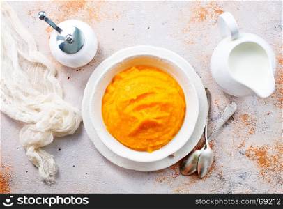 pumpkin porridge in bowl and on a table