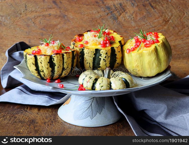 Pumpkin risotto served in a hollowed pumpkin. Baked pumpkin with cheese and pomegranate seeds . Selective focus .. Pumpkin risotto served in a hollowed pumpkin. Baked pumpkin with cheese and pomegranate seeds . Selective focus