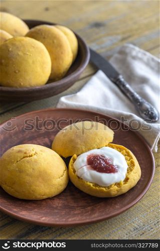 Pumpkin scones with cream and fruit jam