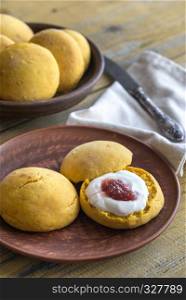 Pumpkin scones with cream and fruit jam