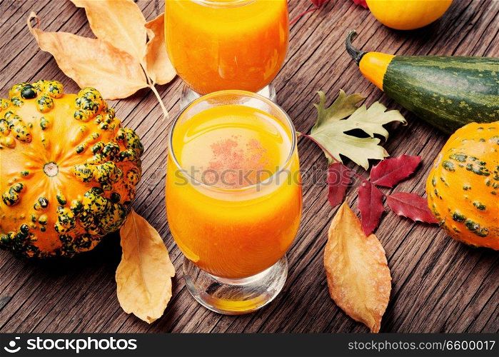 Pumpkin smoothie in a glass on vintage table.Beverage with pumpkins. Healthy pumpkin smoothie