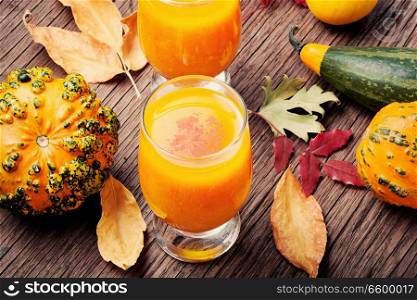 Pumpkin smoothie in a glass on vintage table.Beverage with pumpkins. Healthy pumpkin smoothie