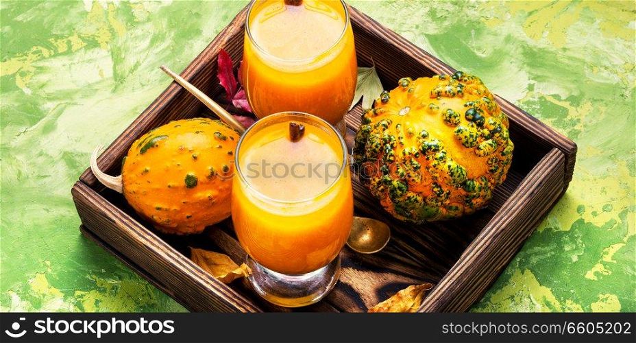 Pumpkin smoothie in glass on vintage table.Autumn drink.. Beverage with pumpkins