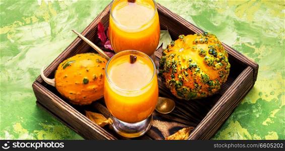 Pumpkin smoothie in glass on vintage table.Autumn drink.. Beverage with pumpkins
