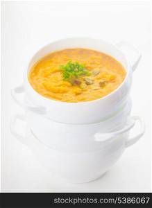 Pumpkin soup in white bowl on the white background