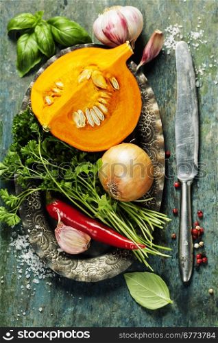 Pumpkin soup ingredients on wooden background close up
