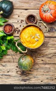 Pumpkin soup on a wooden table.Autumn pumpkin cream soup. Pumpkin vegan soup