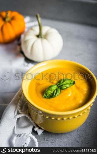 Pumpkin soup on rustic background