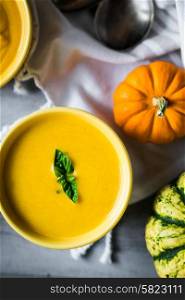 Pumpkin soup on rustic background