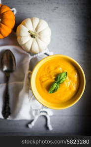 Pumpkin soup on rustic background