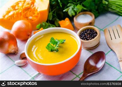 Pumpkin soup served on the table in bowl