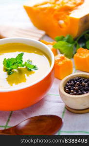 Pumpkin soup served on the table in bowl