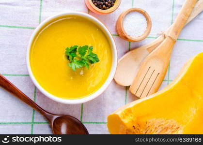 Pumpkin soup served on the table in bowl