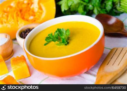 Pumpkin soup served on the table in bowl