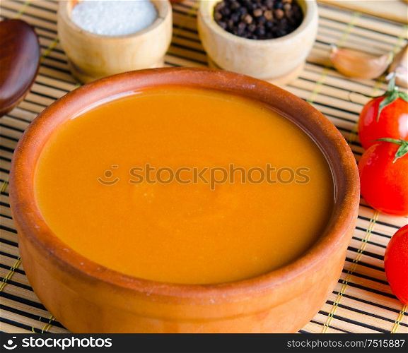 Pumpkin soup served on the table in bowl. The pumpkin soup served on the table in bowl