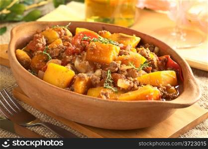 Pumpkin, tomato, mincemeat dish with fresh thyme (Selective Focus, Focus on the pumpkin piece on the top of the meal)