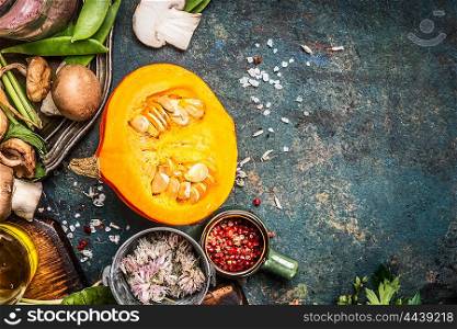 Pumpkin vegetarian cooking with mushrooms ,seasoning and spices, dark rustic background, top view, place for text
