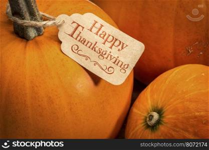 pumpkin with a Happy Thanksgiving paper price tag - holiday shopping concept