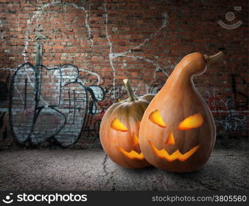 Pumpkins and wall of bricks with graffiti