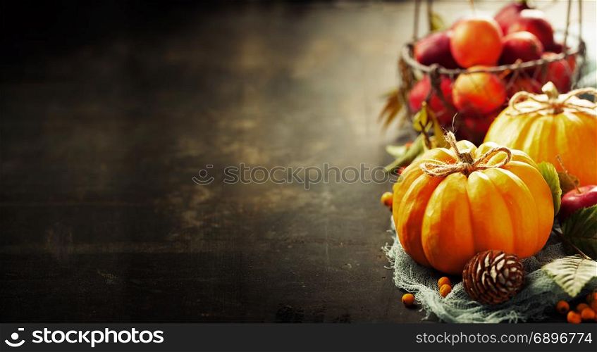Pumpkins composition on rustic background