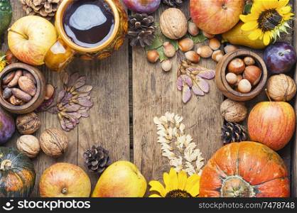 Pumpkins,nut and fruits in autumn still life on wooden table.Fall still life. Autumn harvest still life