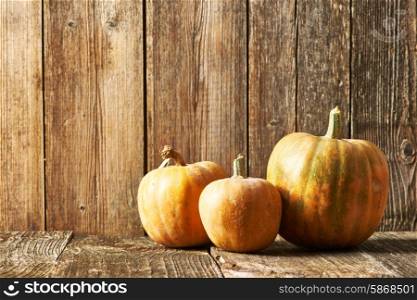 Pumpkins on old wooden table
