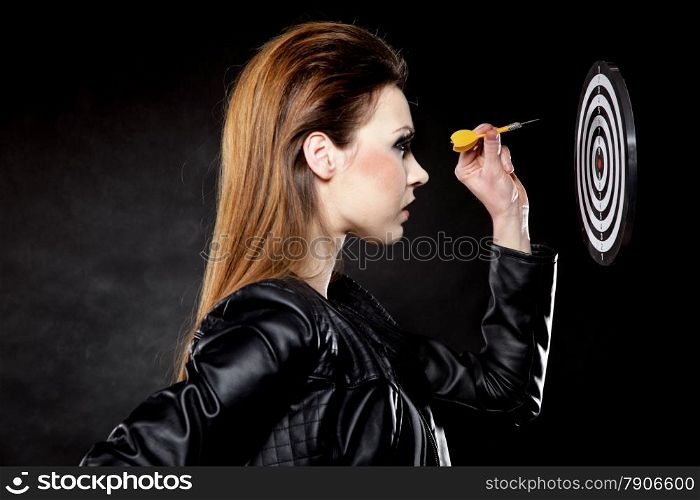 punk girl with arrow dart and target black backgruond