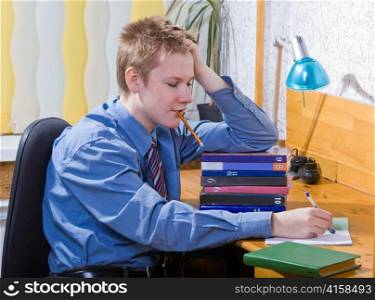 Pupil schoolboy reflected with pile of textbooks above performance of homework