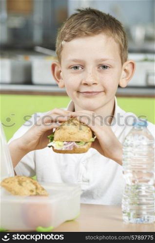 Pupil Sitting In School Cafeteria Eating Healthy Packed Lunch