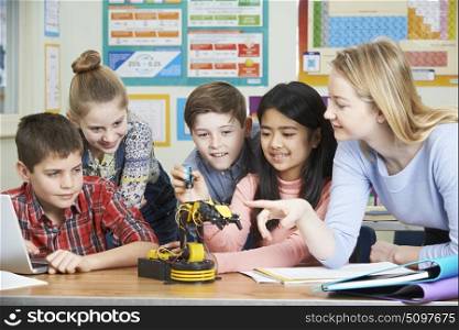 Pupils And Teacher In Science Lesson Studying Robotics