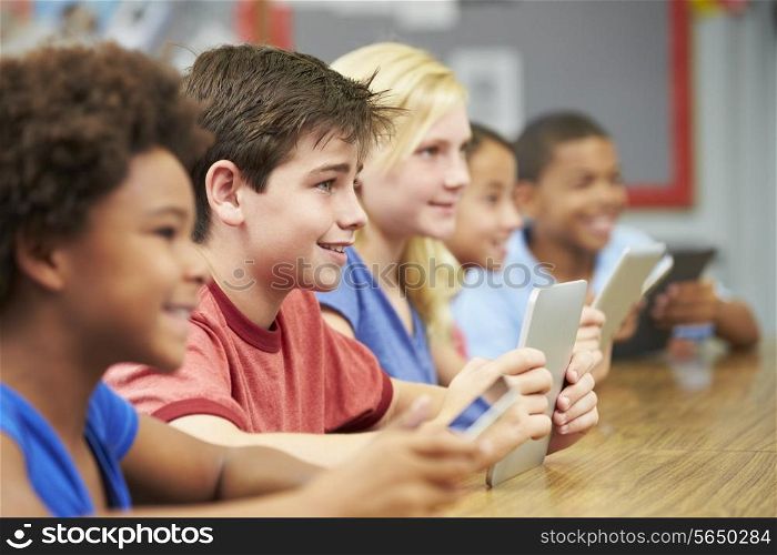 Pupils In Class Using Digital Tablet