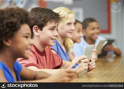 Pupils In Class Using Digital Tablet
