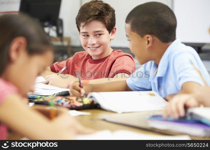 Pupils Studying At Desks In Classroom