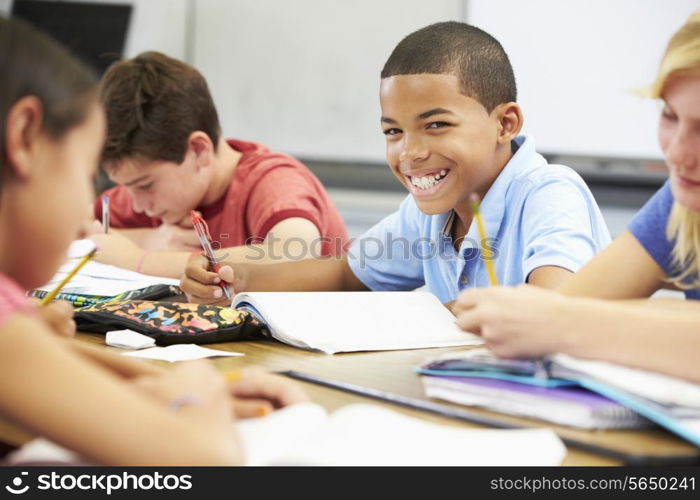 Pupils Studying At Desks In Classroom