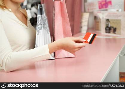 Purchase. The hand holds a credit card against a counter