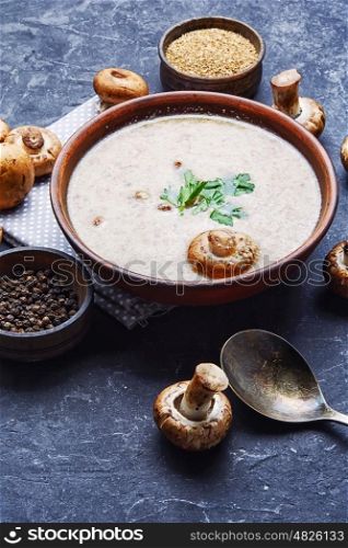 puree soup with mushrooms. seasonal vegetarian soup with chanterelle mushrooms in slate background