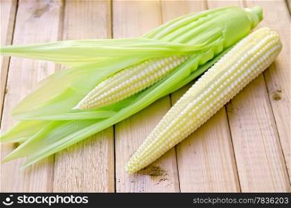 Purified corn cobs on the background of wooden boards