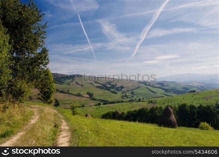 Purity of the sky with airplane&rsquo;s track and road in field