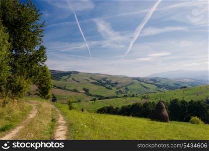 Purity of the sky with airplane&rsquo;s track and road in field