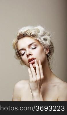 Purity. Sensual Romantic Blond Female with Closed Eyes touching her Face. Muse