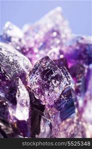 Purple amethyst stone over abstract background for your design