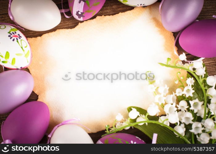 Purple and white eggs and empty greeting card. Easter decorations