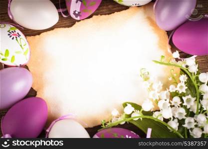 Purple and white eggs and empty greeting card. Easter decorations