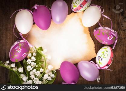 Purple and white eggs and empty greeting card. Easter decorations