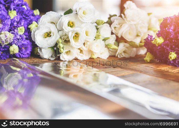 Purple and white flowers on table with reflection