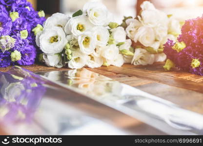 Purple and white flowers on table with reflection