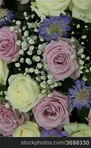 Purple and white roses, mixed with gypsophila and purple love in a mist