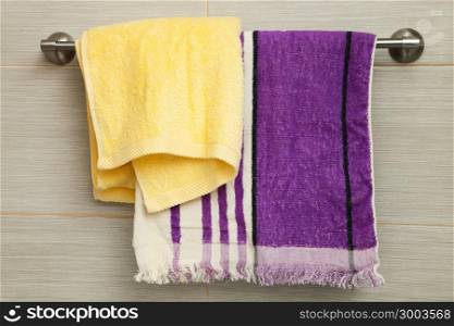 purple and yellow towels in the bathroom